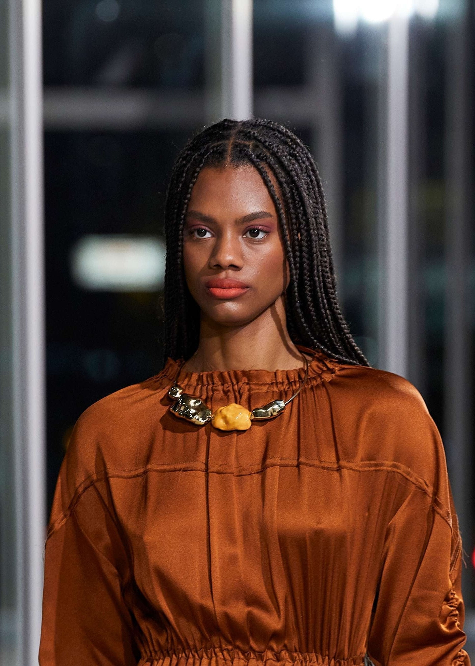 Golden necklace with orange bead